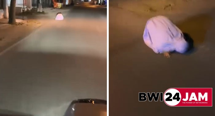 sosok_diduga_perempuan_sujud_di_jalan.jpg